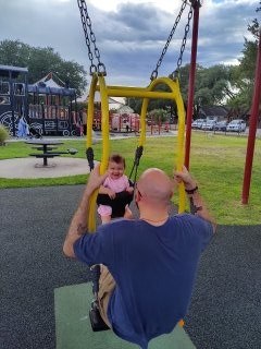 Skye swinging up high at the playground